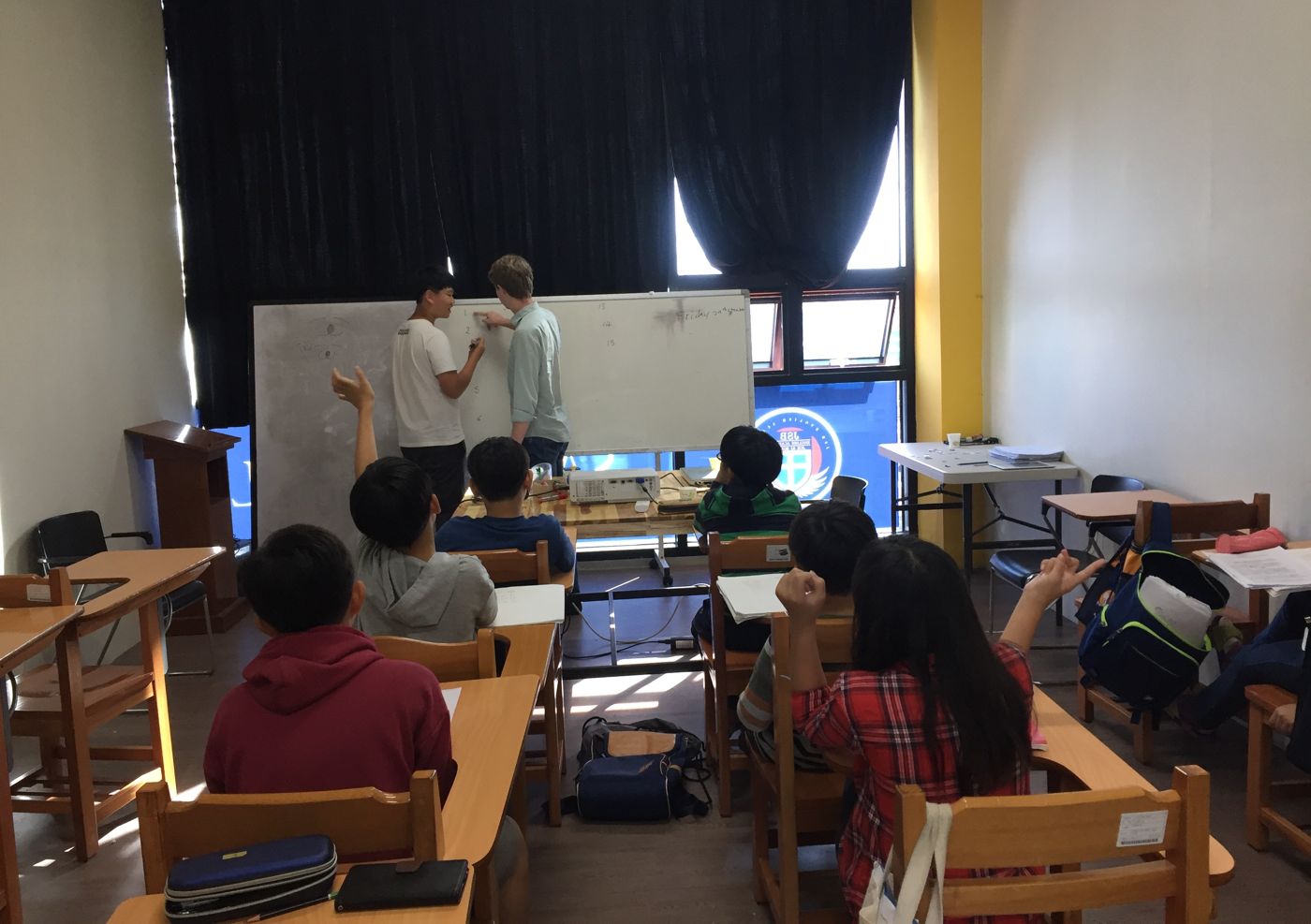 PLEW taught in the classroom — students working from the whiteboard